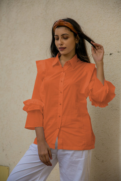 PLEATED FLUTTER SLEEVES SHIRT - A shirt with pleats on the body and frill sleeves is a garment that combines two design elements to create a unique and eye-catching style. It is made of lightweight and breathable fabric.