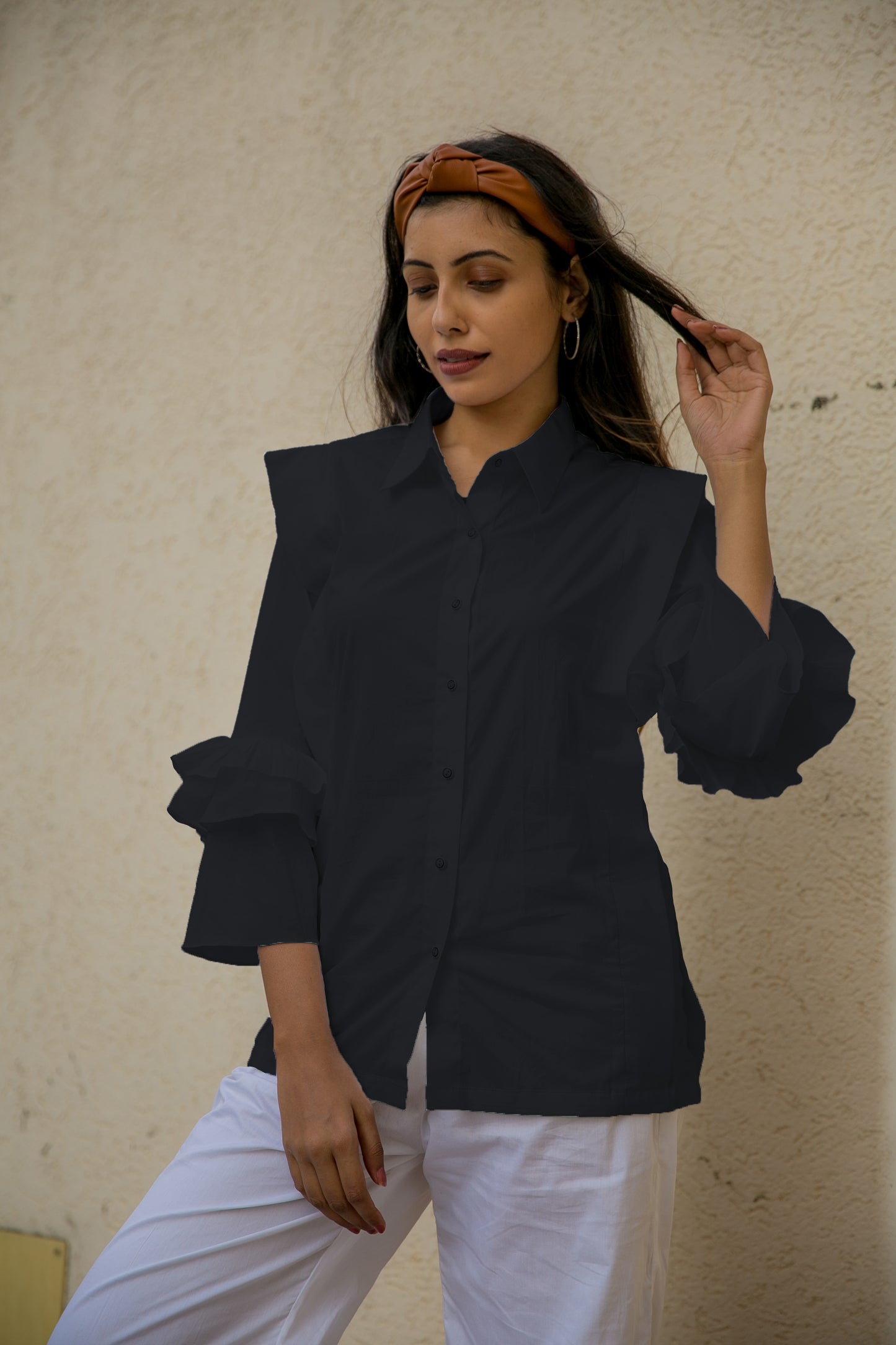 PLEATED FLUTTER SLEEVES SHIRT - A shirt with pleats on the body and frill sleeves is a garment that combines two design elements to create a unique and eye-catching style. It is made of lightweight and breathable fabric.