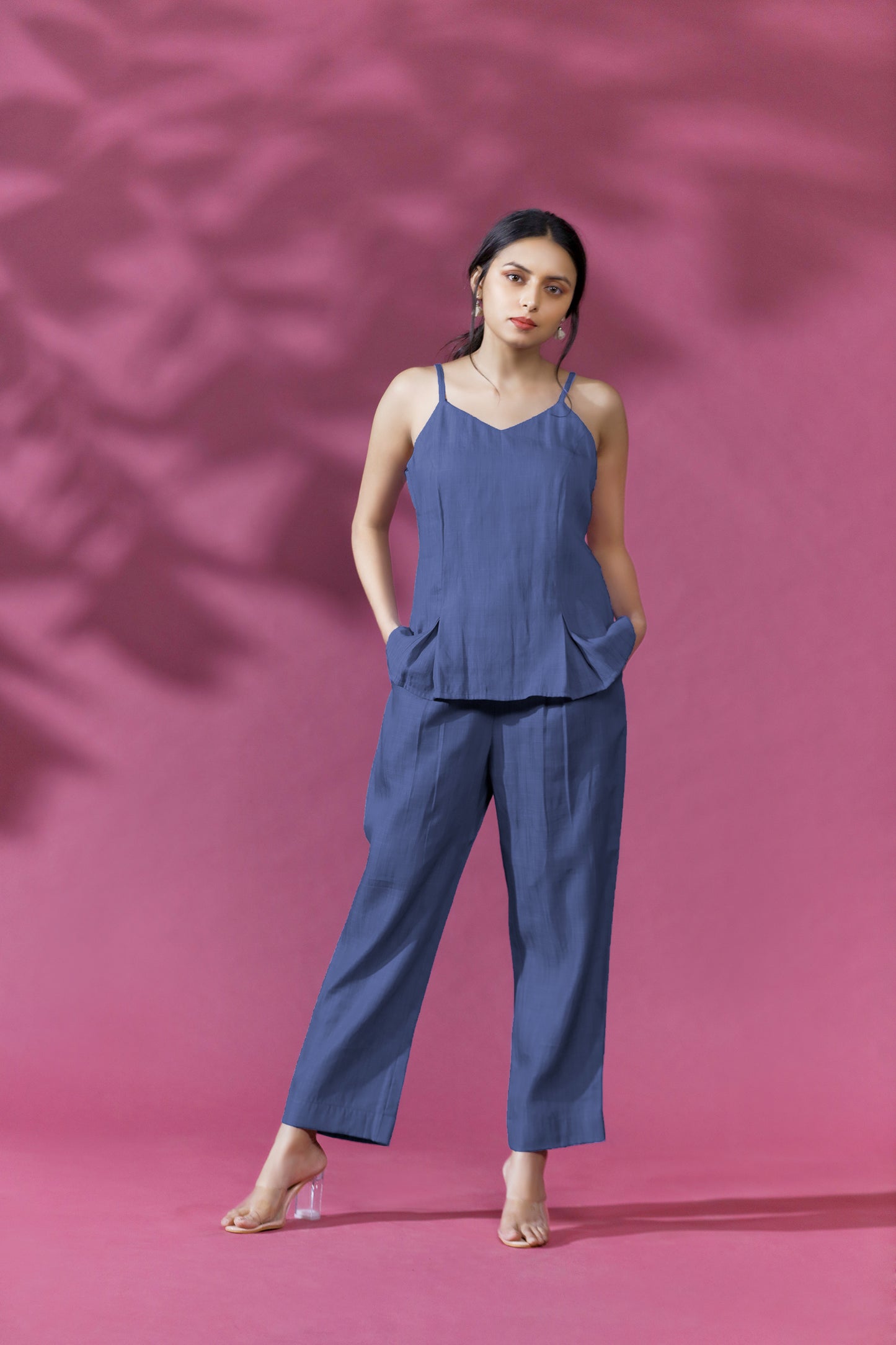 SWEETHEART COORD SET - This is a stylish and versatile ensemble that features a sleeveless top and pants in a soft shade of blue. The top has a corset look , with a V neckline and a flattering fit that flows effortlessly over the body. The pants are also made from the same chambray blue fabric as the top, creating a cohesive and stylish look when worn together.