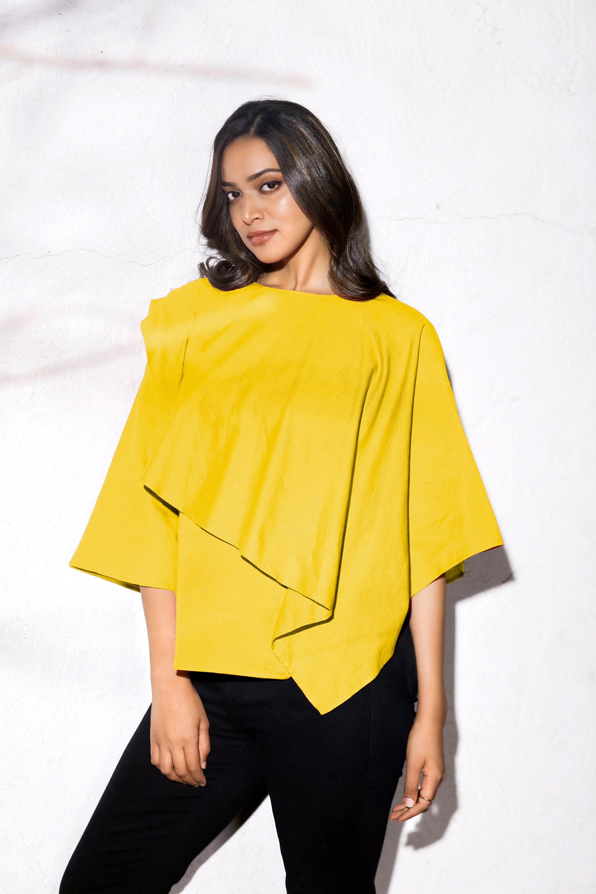 LAYERED SHAWL TOP - This top features a layer of fabric draped over the body in a shawl-like manner. The layer adds volume and dimension to the garment. The shawl-like draping creates a unique and elegant silhouette, making it a popular choice for formal occasions or as a statement piece.