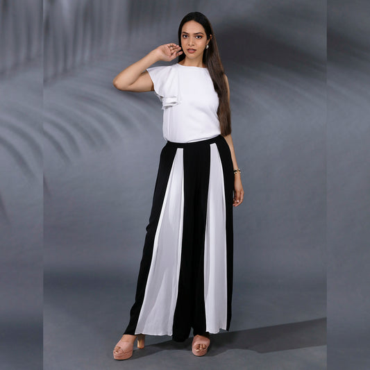 SOIREE COORD SET - This a classy and stylish set. The top has a one side frill sleeve and the pant has inverted pleats at the front in contrasting colours giving it a statement look. This combination is versatile and can be worn to work or social events.