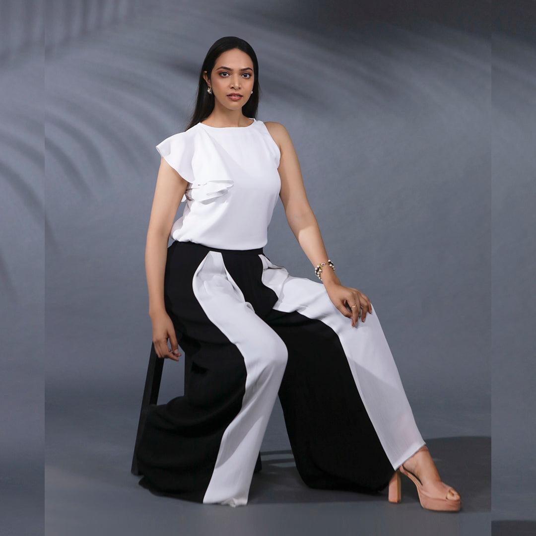 SOIREE COORD SET - This a classy and stylish set. The top has a one side frill sleeve and the pant has inverted pleats at the front in contrasting colours giving it a statement look. This combination is versatile and can be worn to work or social events.